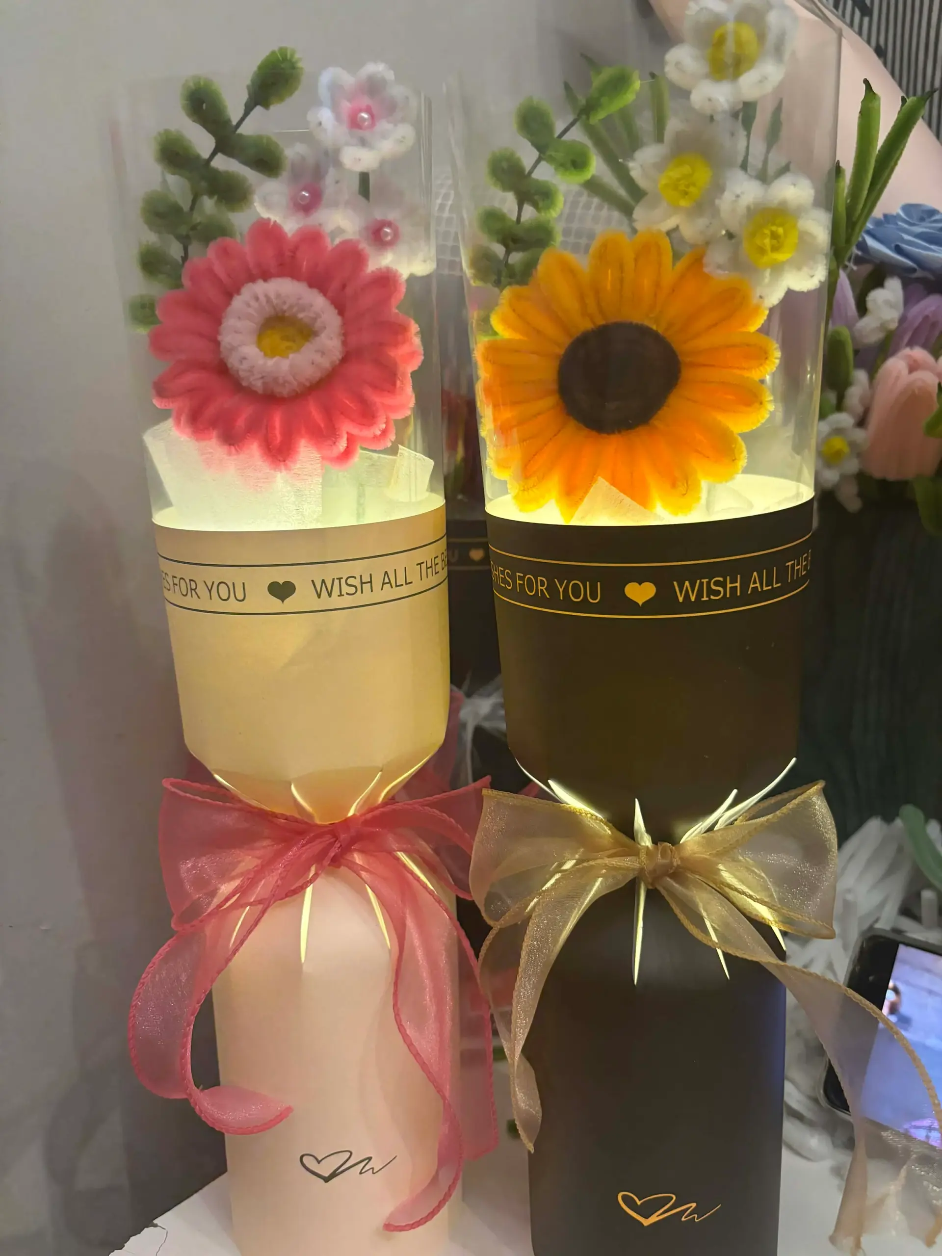 FleurKraft LED light bouquets â€” sunflower and gerbera daisy designs in gift cylinders