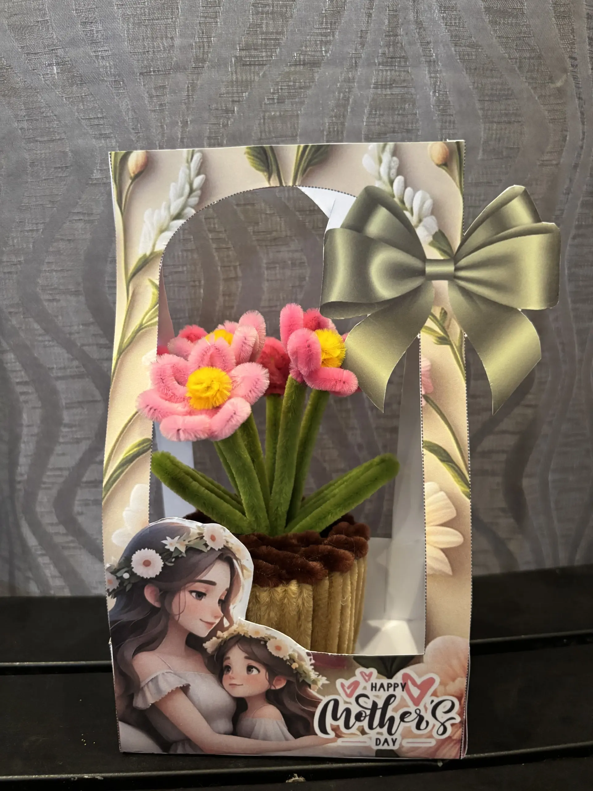 FleurKraft mini pot salmon â€” coral-toned fuzzy wire flower in a woven basket pot with gift packaging