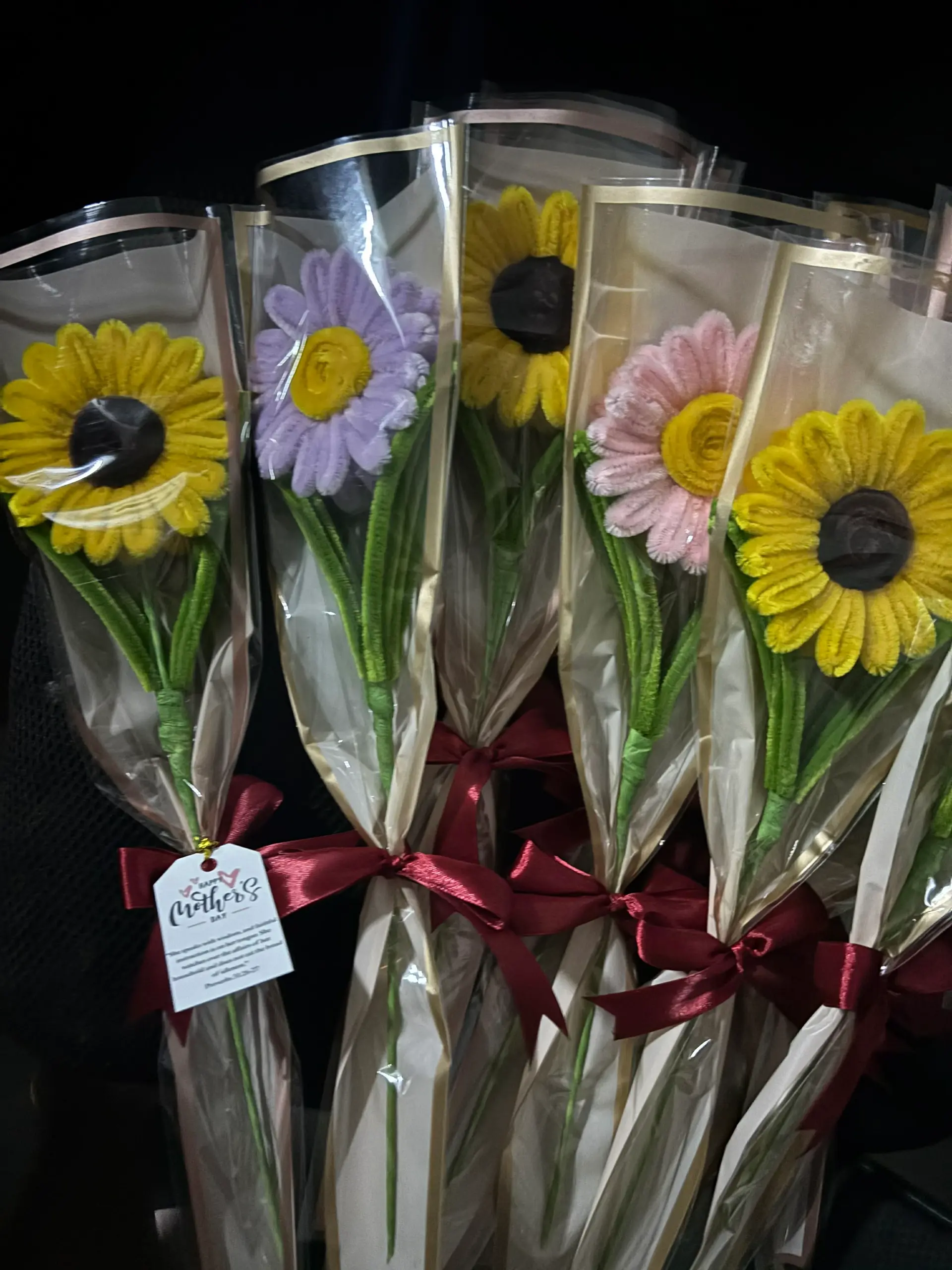 FleurKraft single-stem gerbera bouquets in a row — yellow, lilac, pink, and sunflower colors